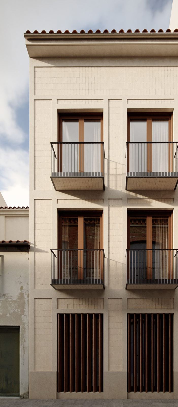 The facade of Escalante 21: cream tile, framed windows, walnut shutters