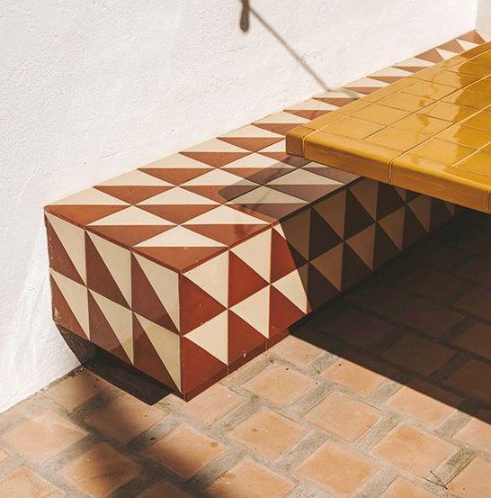 Bench clad in triangle tiles